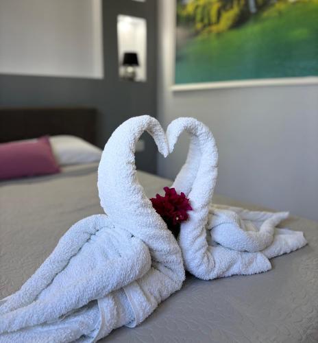 two towels in the shape of swans on a bed at Panorama Apartments in Prinos
