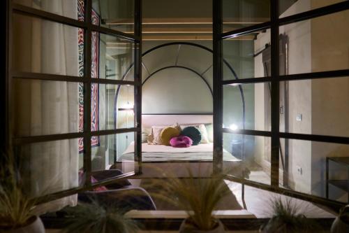 a bedroom with a bed in a room with a window at La SERAFINA in Vanzaghello