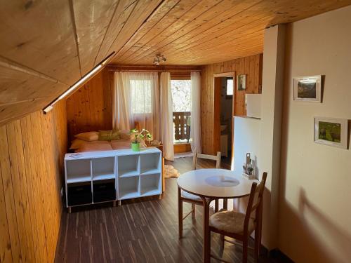 a room with a small table and a room with a bed at Haus Bergblick in Größing