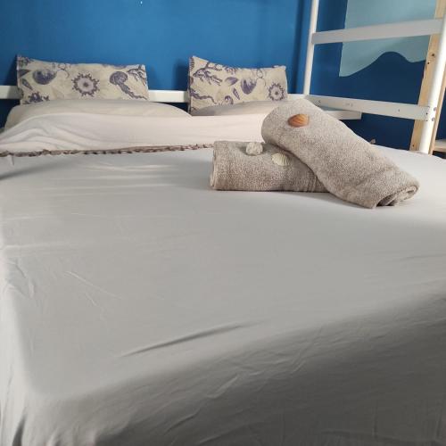 a stuffed animal sitting on top of a bed at casa MAREA in Lido Marini