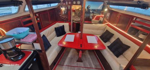 a red table in the back of a boat at Voilier de tout confort in Cherbourg en Cotentin