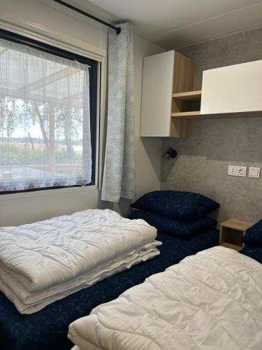 a bedroom with a bed and a large window at Panorama Best View in Lauwersoog