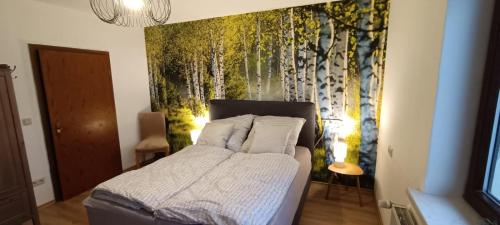 a bedroom with a bed with a wall mural at Ferienwohnung Urlaubszeit in Illingen