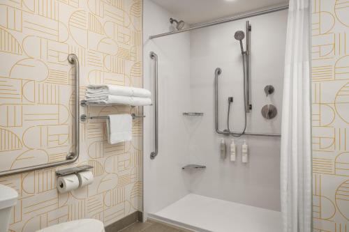 a bathroom with a shower and a toilet at Home2 Suites By Hilton Vaughan Toronto On in Vaughan