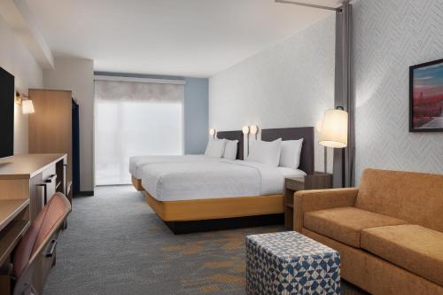 a hotel room with a bed and a couch at Home2 Suites By Hilton Vaughan Toronto On in Vaughan