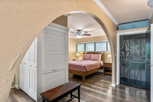 a bedroom with a bed and a ceiling fan at Kalani Kai#104 in Kailua-Kona
