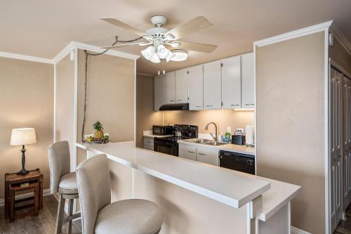a kitchen with a counter and a ceiling fan at Kalani Kai#104 in Kailua-Kona