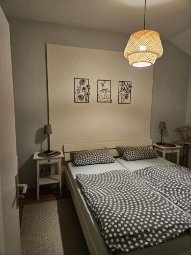 a bedroom with a large bed and a chandelier at Haus Vis a Vis 1 in Stromberg