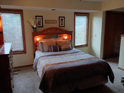 a bedroom with a large bed and two windows at Poplar Estate in Lincoln