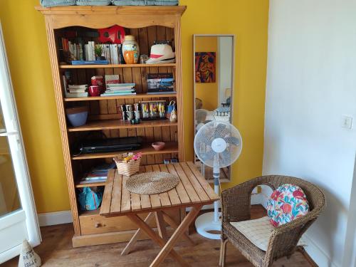 a room with a table and a book shelf at Appartement avec Terrasse à Beaurivage in Biarritz