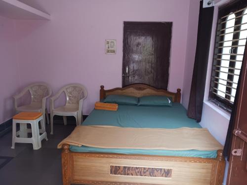 a bedroom with a wooden bed in a room at GARDEN villa, Vanasthalipuram in Hyderabad