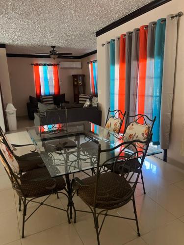 a glass table and chairs in a living room at Steps Away from Adventure -2bedroom & 2 Bath in Turtle Cove