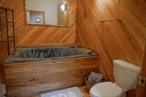 a wooden bathroom with a tub and a toilet at 2 Br Plus Loft: Hawthorne Valley 4 in Snowshoe