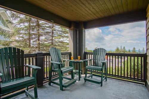 a porch with three chairs and a table with candles at Rimfire 151- 152 Unique 2 Br Condo in Snowshoe