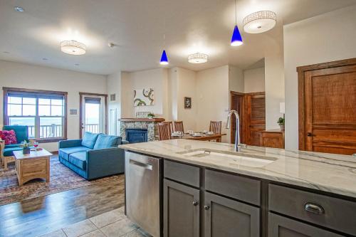a kitchen and living room with a sink and a couch at Soaring Eagle #403: 2 Bedrooms, 2 Full Baths in Snowshoe