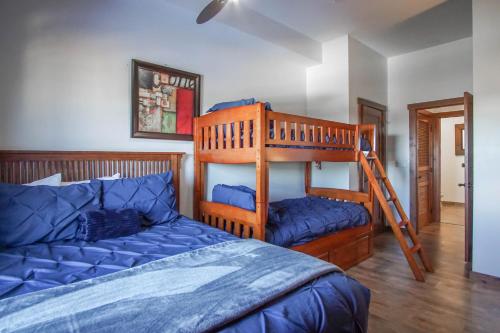 a bedroom with a bunk bed and a blue bed at Soaring Eagle #403: 2 Bedrooms, 2 Full Baths in Snowshoe