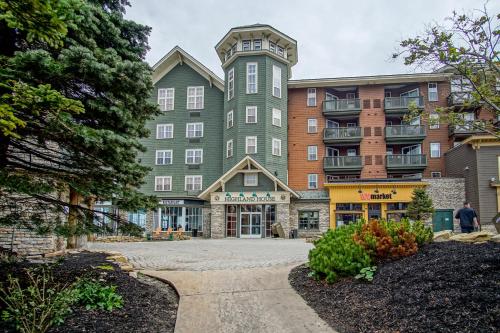 a large green building with at Highland House #102-104: 2Br: 2 Bath in Snowshoe