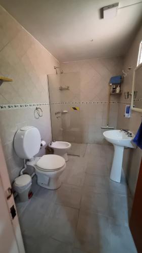 a bathroom with two toilets and a sink at El Pilo in Centenario