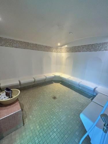 a room with a swimming pool with benches at Hotel Phönix in Bad Füssing