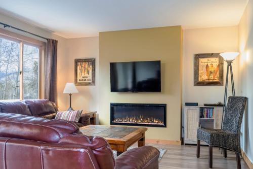 a living room with a couch and a fireplace at Cozy 2BR with Great Views Near Trails in Silverthorne