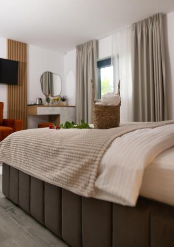 a bedroom with a bed with a basket on it at Casa de Vacanta Magherus in Topliţa