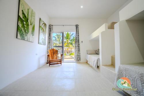 a corridor of a bedroom with a bed and a chair at Villa Moka 2 in Taxisco