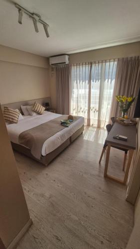 a large bedroom with a large bed and a table at DAKAR HOTEL in Mendoza