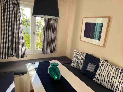a living room with a glass vase on a table at Tranquility House Astros in Paralio Astros