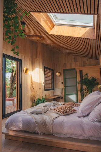 a bedroom with a large bed with a skylight at Idylle du Causse in Cénevières