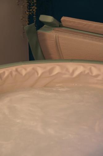 a close up of a bed with white sheets at Le Patio Spa in Chartres
