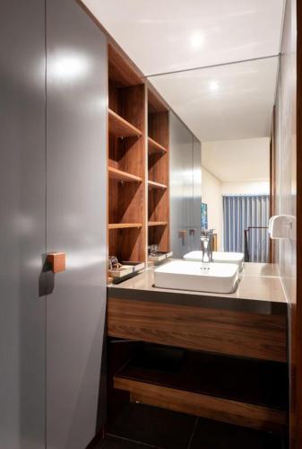 a bathroom with a white sink and a counter at Solari 15F Duplex Suite with Nhat Tan Bridge View in Hanoi