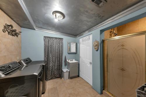 a kitchen with blue walls and a sink and a stove at Charming Atlanta Home in Atlanta