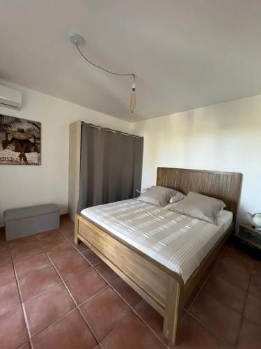a bedroom with a large bed in a room at O Ti Boneur in Sainte-Rose