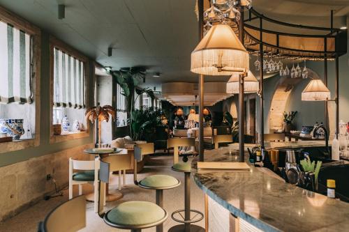 a bar in a restaurant with stools at Torel Terra Brava in Angra do Heroísmo