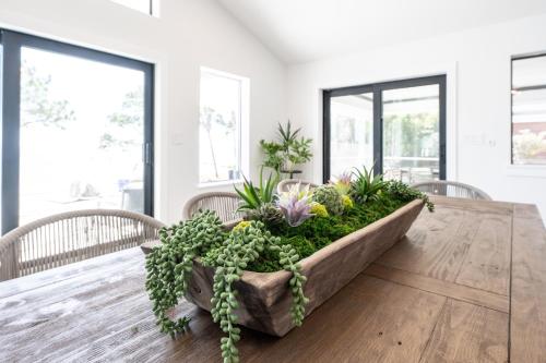 a dining room table with plants on it at Sea La Vi in Navarre