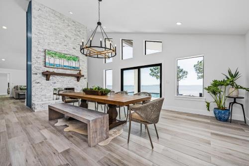 a dining room with a wooden table and a bench at Sea La Vi in Navarre