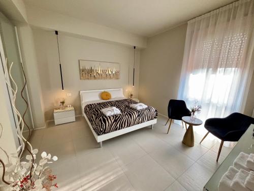 a bedroom with a zebra print bed and a table at Salotto Santa Franca in Piacenza
