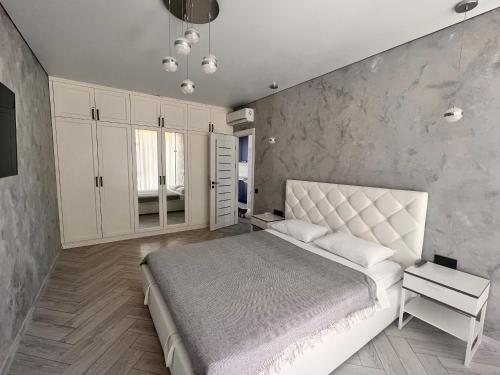 a bedroom with a large bed and white cabinets at Golden Bugas Sea View Золотий бугаз in Karolino-Buhaz