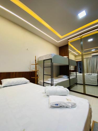 a bedroom with two beds and a mirror at Flat 02 Residencial ibiapaba in Camocim