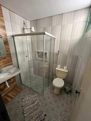 a bathroom with a shower and a toilet and a sink at Hospedaria de Maria in Tiradentes