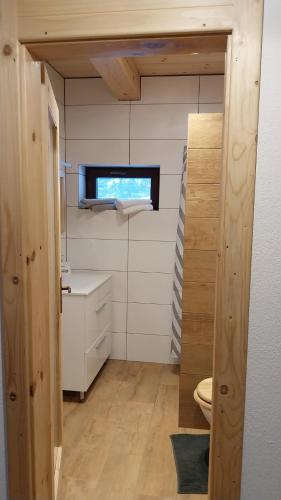 a small bathroom with a toilet and a window at Chata pod Kriváňom in Východná