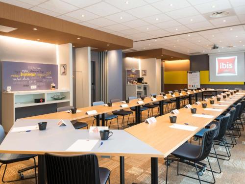 a conference room with long tables and chairs at ibis Lyon Part Dieu Les Halles in Lyon