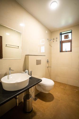 a bathroom with a sink and a toilet at Mistral by the sea in Benaulim