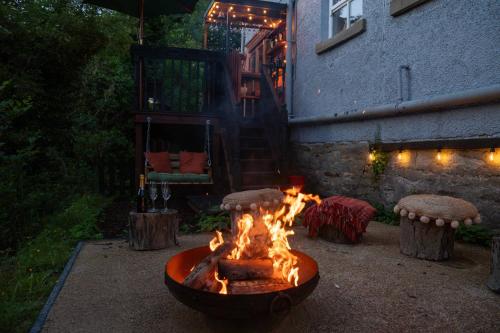 a fire pit in a yard next to a building at River Cottage at Old Post Office in Bardon Mill