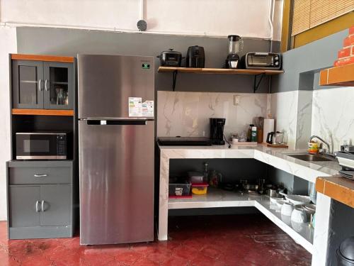 a kitchen with a stainless steel refrigerator at Casa Girasol PZ in San Isidro