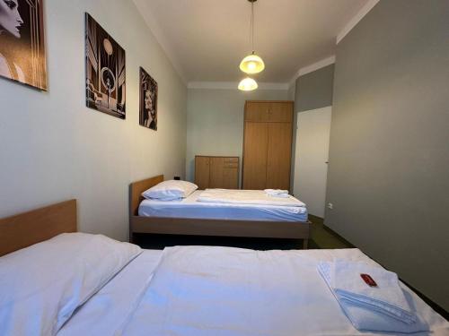 two beds in a small room with two beds at Mariazellerhof Suite 016 in Sankt Pölten