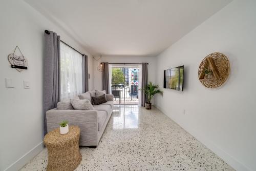 a living room with a couch and a table at Wynwood Charm, at the Heart of the Art! in Miami
