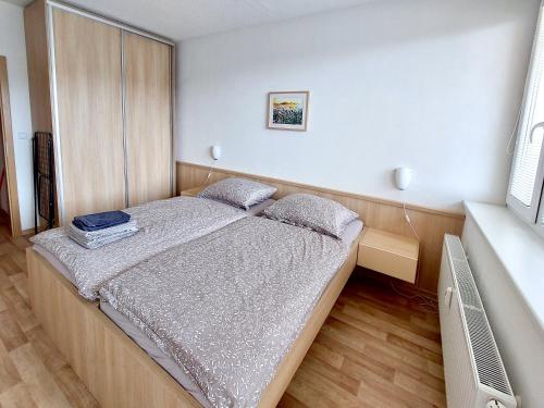 a small bedroom with a bed in a room at Apartmán Všemina 300 in Všemina