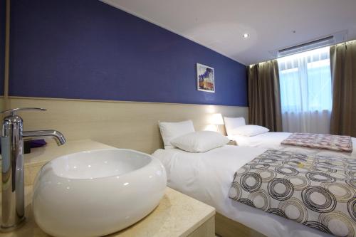 Ένα ή περισσότερα κρεβάτια σε δωμάτιο στο Hotel Sopra Incheon Cheongna
