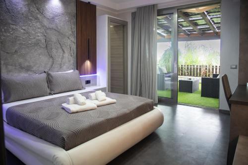 a bedroom with a bed with two towels on it at Residence Villa Rosa dei Venti in Cinisi